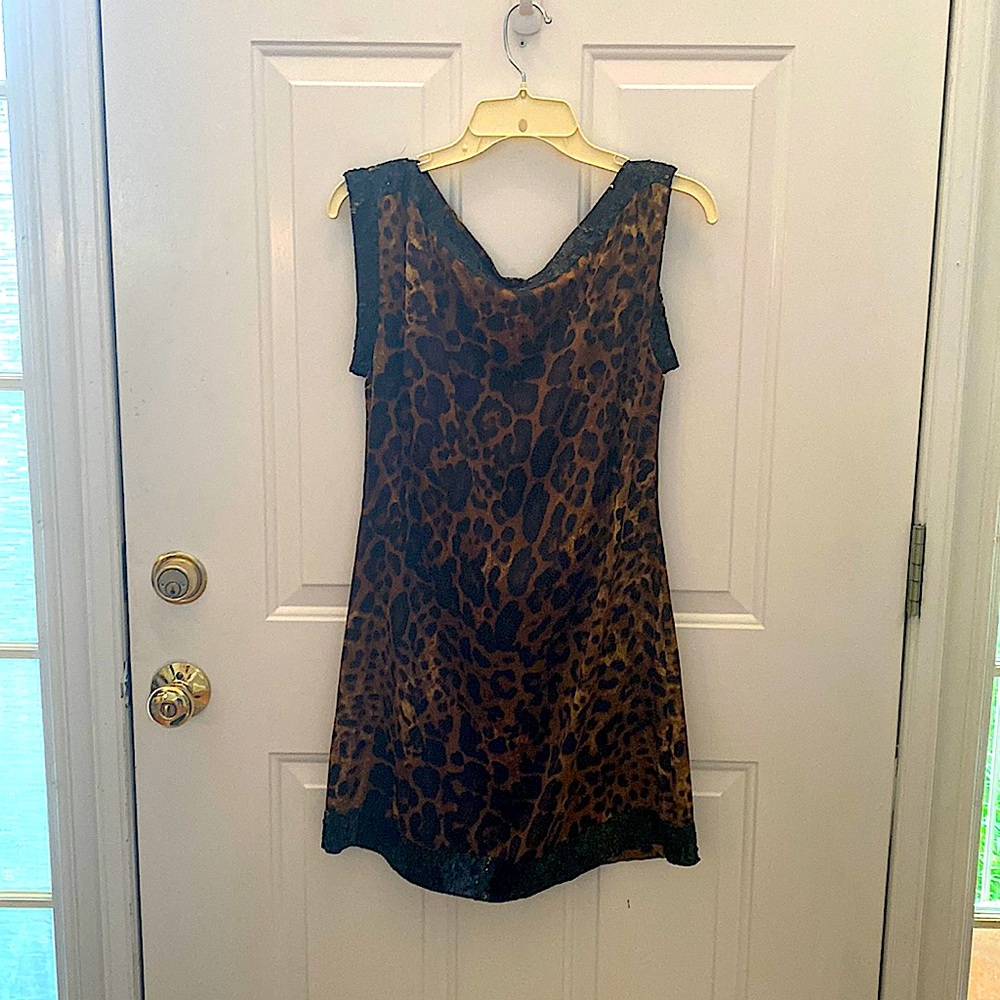 Brown cheetah dress with black sequins around the arm holes and neck line